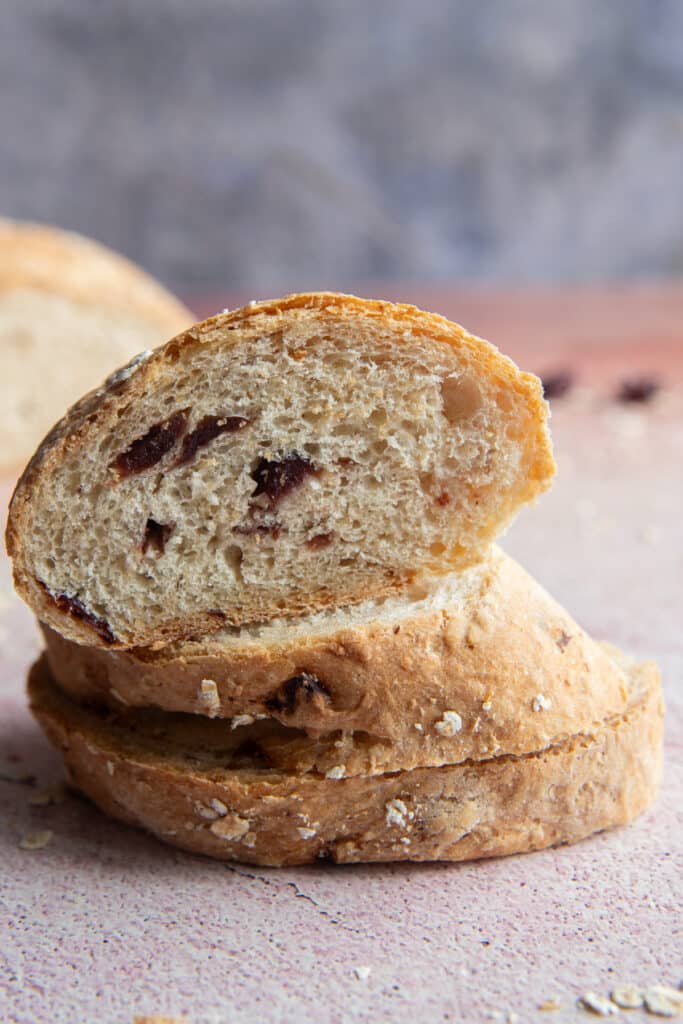Three slices of cranberry and oats bread on top of the other.
