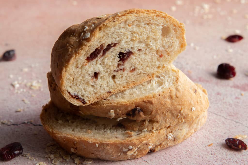 Three slices of cranberry bread one on top of the other.