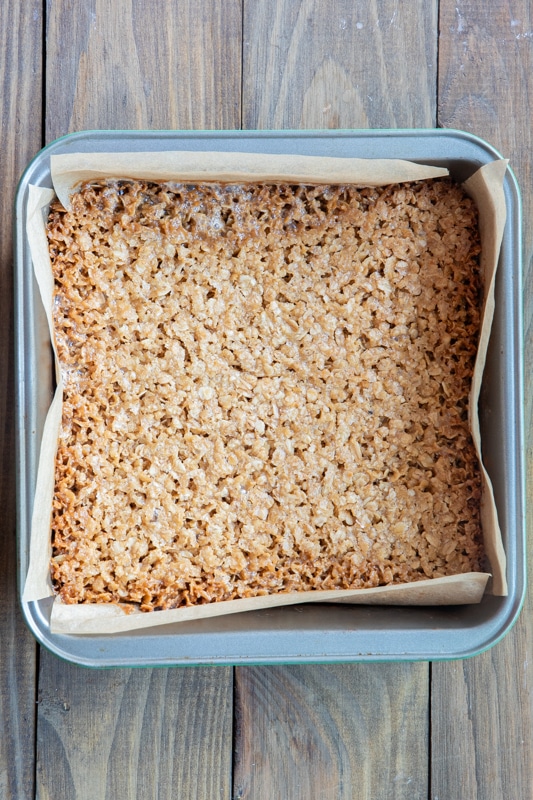 Baked flapjack in a square pan.