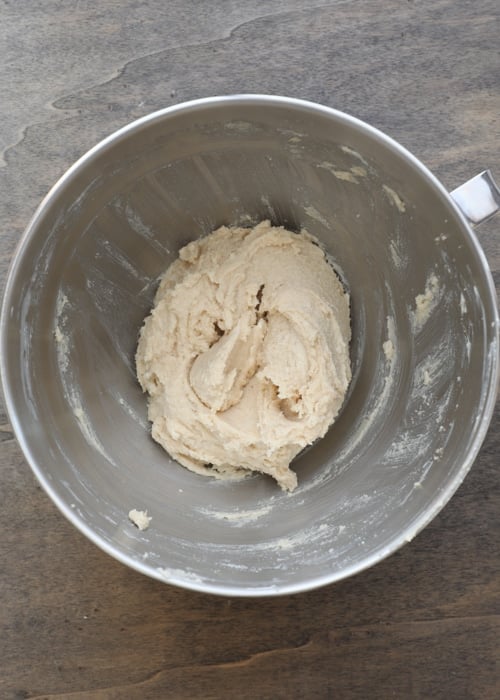 Butter and sugars mixed in a mixing bowl.