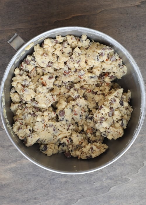 Eggs added to form a cookie dough in a mixing bowl.