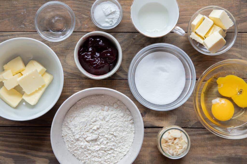 Ingredients to make Bakewell bars in separate bowls.