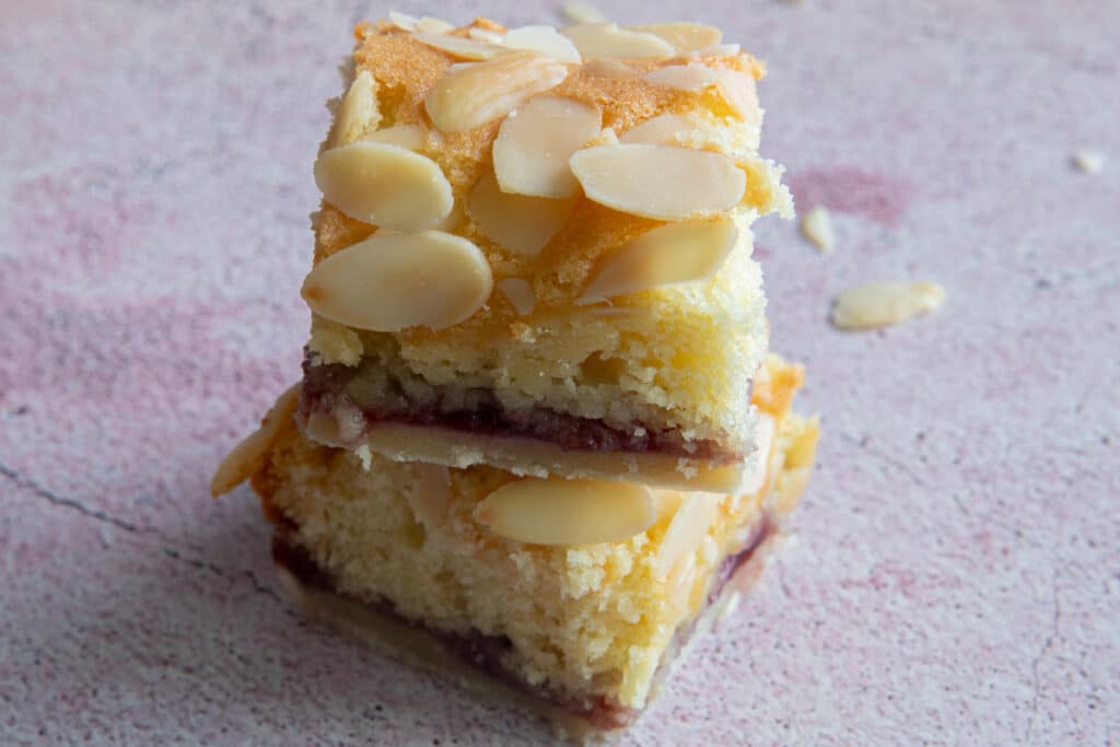 Two Bakewell bar slices one on top of the other.
