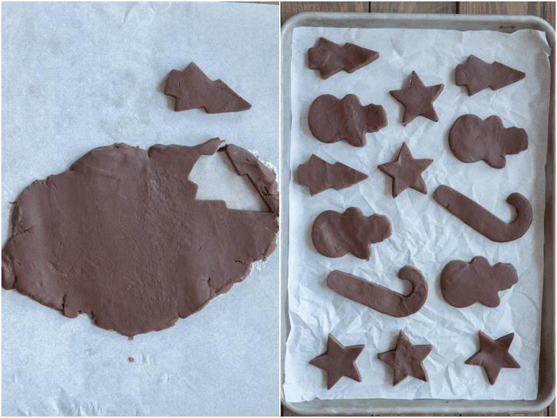Cookie dough flattened and cut out into christmas cookies and placed on a baking sheet.