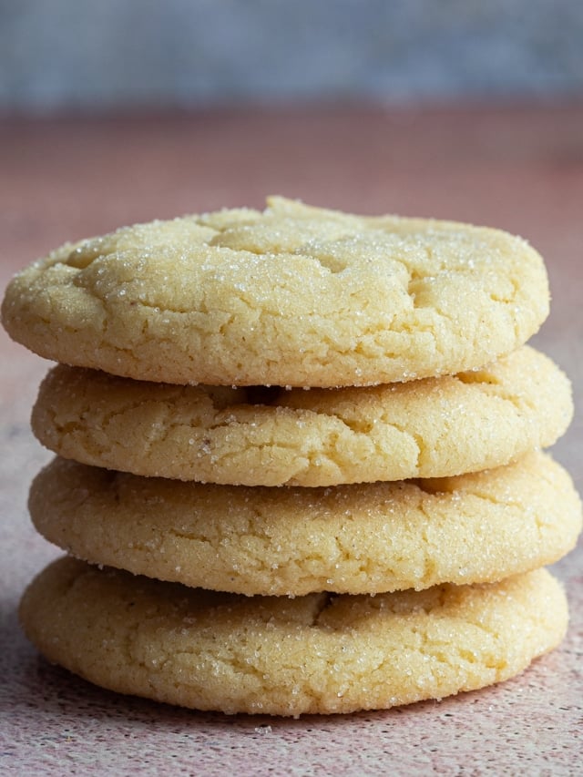 Four vanilla sugar cookies stacked.