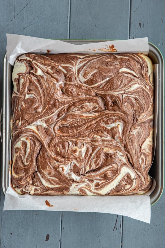 Baked cream cheese brownies in a baking pan.