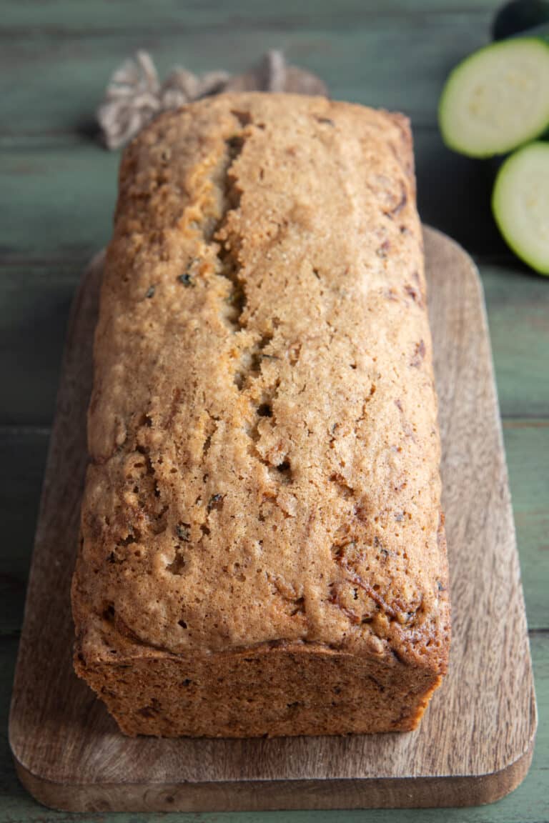 A whole zucchini loaf on a wooden board.