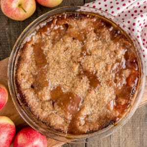 A bottomless apple pie in a pie dish.