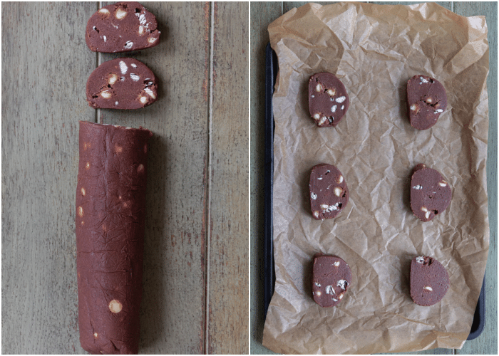 Crunchy white chocolate chip cookie dough log cut into slices and placed on top of a baking sheet.
