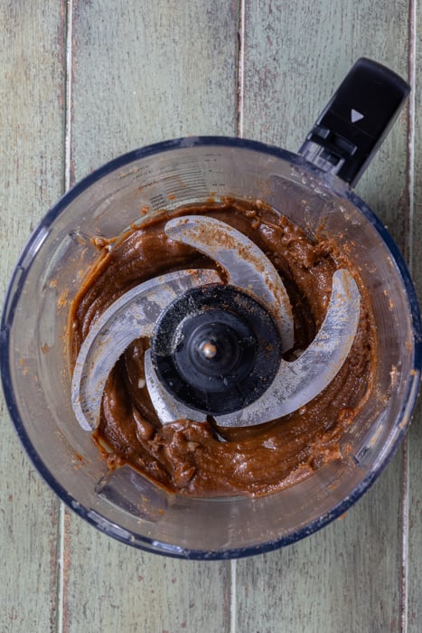 Olive oil and spices added into the food processor and blended.