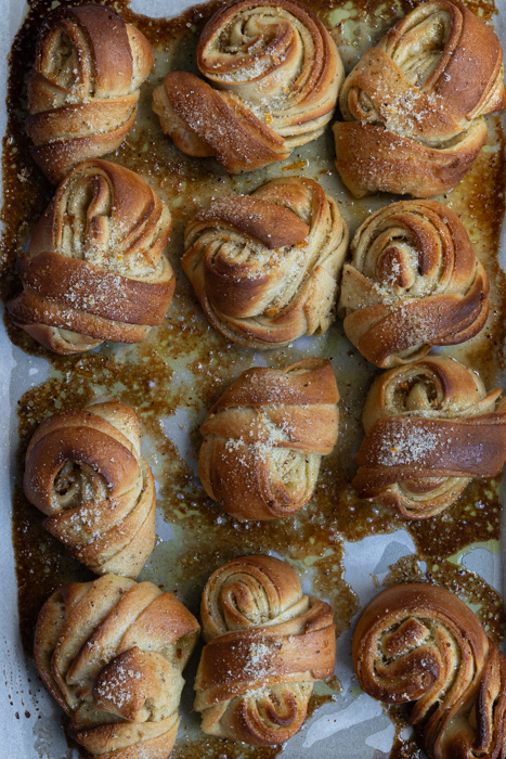 Baked blood orange cardamom buns on a tray.