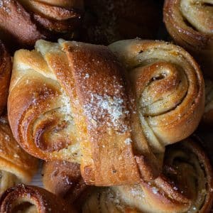 Blood orange cardamom bun surrounded by other cardamom buns.