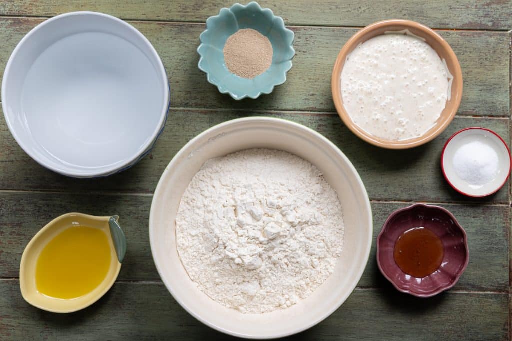 Sourdough discard focaccia ingredients in separate bowls.