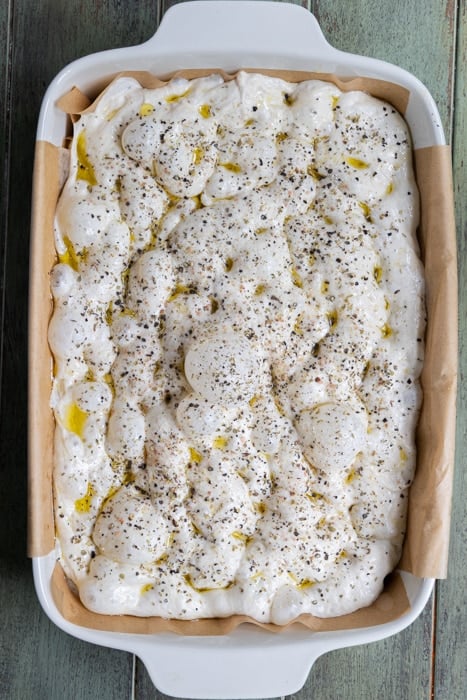 Discard focaccia in a baking dish ready to be baked.